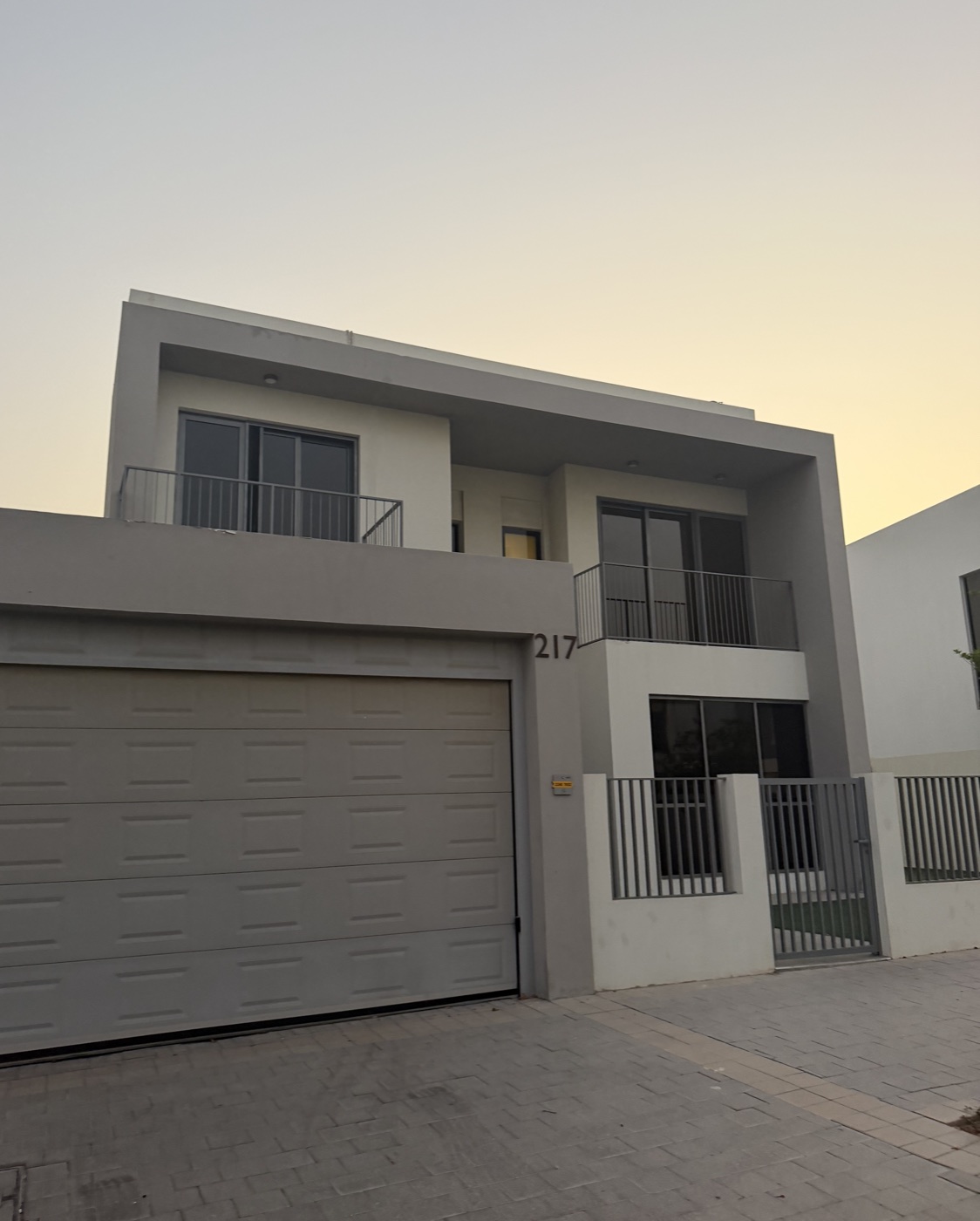 Exterior of Villa 217 in Sidra 1, showing the garage, balcony and villa number